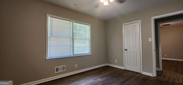 2663 Washington St NW, Atlanta, GA 30318 - unfurnished bedroom featuring dark wood-style floors and a ceiling fan
