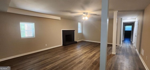 2663 Washington St NW, Atlanta, GA 30318 - unfurnished living room featuring dark wood-type flooring, a ceiling fan, and a fireplace with raised hearth