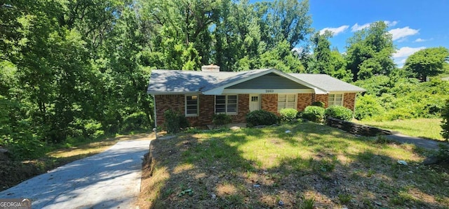 2663 Washington St NW, Atlanta, GA 30318 - view of front of home featuring driveway, brick siding, and a chimney