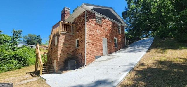 2663 Washington St NW, Atlanta, GA 30318 - view of side of home featuring a balcony, brick siding, a chimney, and stairs