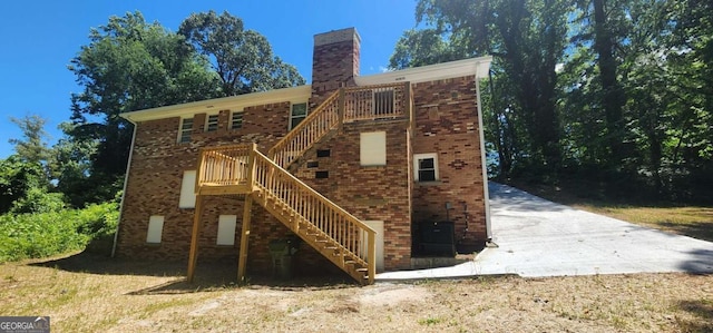 2663 Washington St NW, Atlanta, GA 30318 - rear view of property with stairway, a chimney, and brick siding