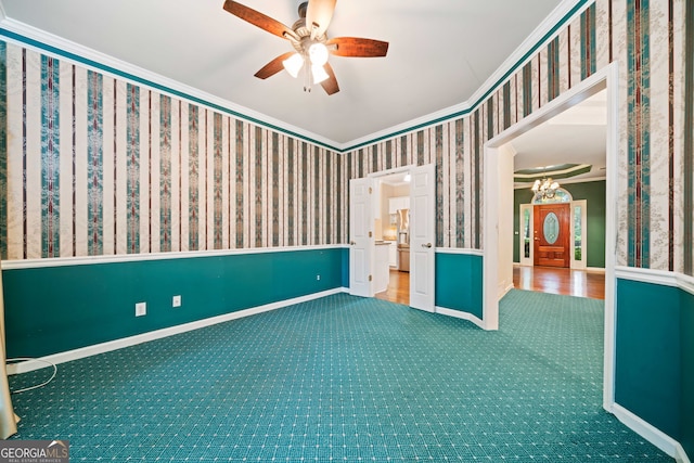 120 Bent Creek Dr, Woodstock, GA 30189 - spare room with crown molding, carpet flooring, a ceiling fan, wallpapered walls, and baseboards