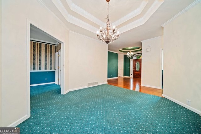 120 Bent Creek Dr, Woodstock, GA 30189 - carpeted empty room featuring a chandelier, ornamental molding, a tray ceiling, and baseboards