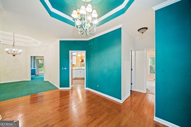 120 Bent Creek Dr, Woodstock, GA 30189 - unfurnished dining area with a chandelier, a tray ceiling, hardwood / wood-style flooring, ornamental molding, and baseboards
