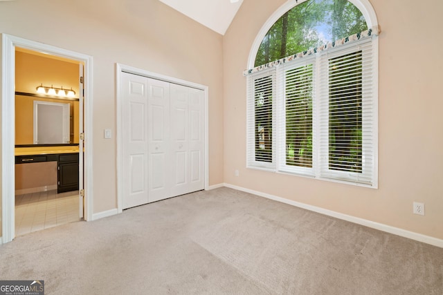 120 Bent Creek Dr, Woodstock, GA 30189 - unfurnished bedroom with carpet flooring, multiple windows, vaulted ceiling, connected bathroom, and a closet