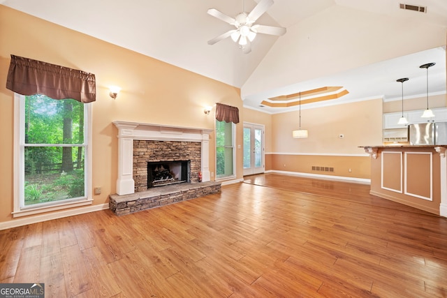 120 Bent Creek Dr, Woodstock, GA 30189 - unfurnished living room with a ceiling fan, light wood-style flooring, baseboards, vaulted ceiling, and a fireplace