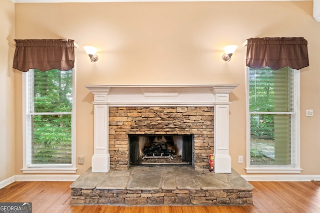120 Bent Creek Dr, Woodstock, GA 30189 - detailed view of wood finished floors, a stone fireplace, and baseboards