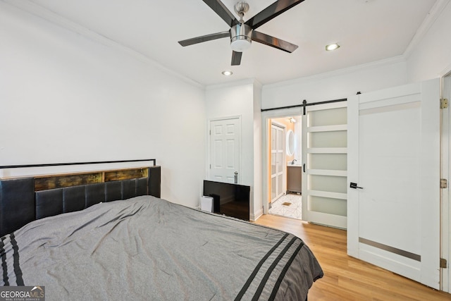 999 Smith St SW, Atlanta, GA 30310 - bedroom featuring ornamental molding, wood finished floors, a barn door, recessed lighting, and ensuite bath