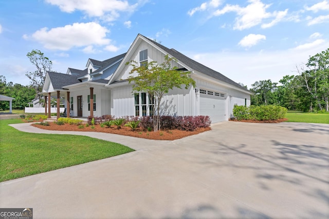 31 Bitter End Ct, Waverly, GA 31565 - view of home's exterior featuring driveway, a garage, a yard, and a porch