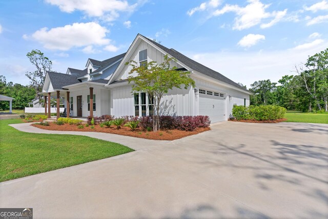 31 Bitter End Ct, Waverly, GA 31565 - view of property exterior with driveway, a garage, a yard, and a porch