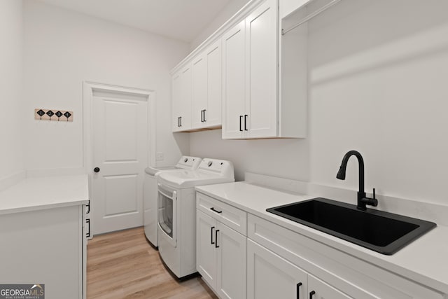 31 Bitter End Ct, Waverly, GA 31565 - washroom with cabinet space, washer and clothes dryer, and light wood-style floors