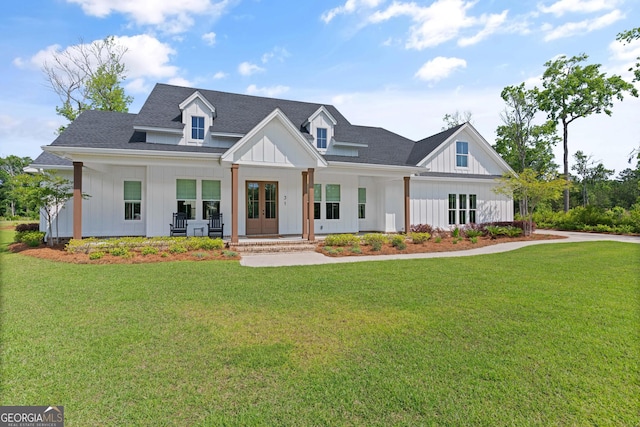 31 Bitter End Ct, Waverly, GA 31565 - modern farmhouse style home with board and batten siding, covered porch, and a front lawn
