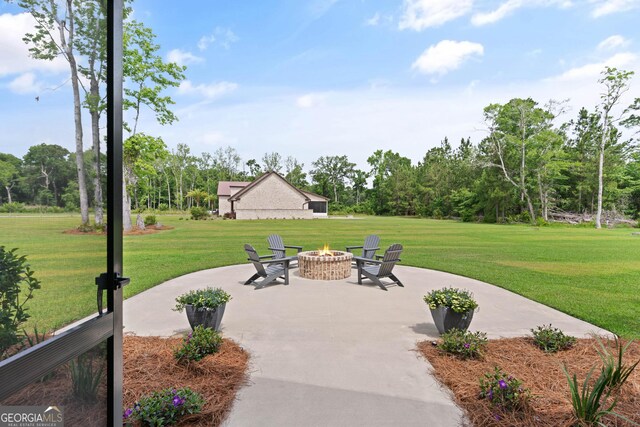 31 Bitter End Ct, Waverly, GA 31565 - view of patio / terrace with an outdoor fire pit and view of wooded area