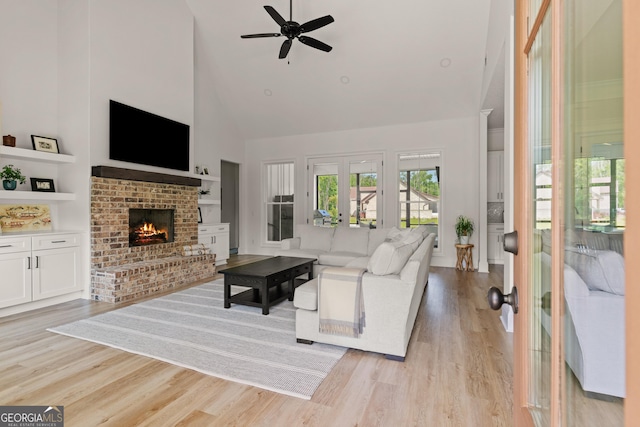 31 Bitter End Ct, Waverly, GA 31565 - living room featuring high vaulted ceiling, light wood finished floors, a ceiling fan, a fireplace, and french doors