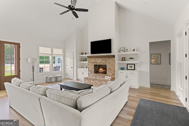 31 Bitter End Ct, Waverly, GA 31565 - living room with high vaulted ceiling, a ceiling fan, baseboards, a fireplace, and light wood finished floors