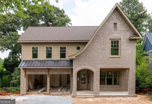 1115 Ralph Rd NE, Atlanta, GA 30324 - view of front of house featuring brick siding, a standing seam roof, a metal roof, roof with shingles, and covered porch