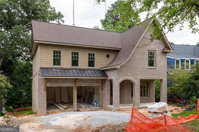 1115 Ralph Rd NE, Atlanta, GA 30324 - view of front of house with brick siding, a standing seam roof, a metal roof, a shingled roof, and driveway