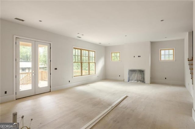 1115 Ralph Rd NE, Atlanta, GA 30324 - unfurnished living room featuring french doors, plenty of natural light, and a fireplace