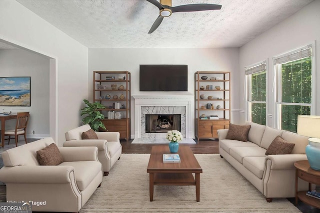 3774 Seasons Dr NW, Acworth, GA 30101 - living area with a ceiling fan, a textured ceiling, wood finished floors, and a premium fireplace