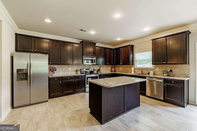 1148 Abe Lincoln Way, Jefferson, GA 30549 - kitchen with stainless steel appliances, crown molding, dark brown cabinets, backsplash, and recessed lighting