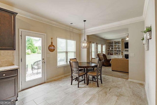 1148 Abe Lincoln Way, Jefferson, GA 30549 - dining area with a fireplace, baseboards, crown molding, built in shelves, and ceiling fan