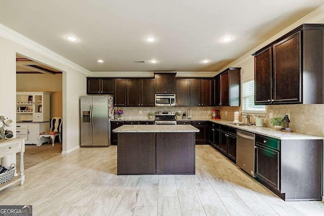 1148 Abe Lincoln Way, Jefferson, GA 30549 - kitchen featuring stainless steel appliances, crown molding, dark brown cabinets, decorative backsplash, and a center island