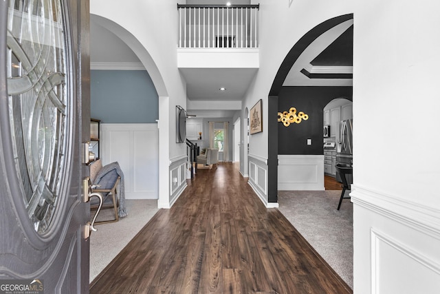 3 Stonebridge Way, Newnan, GA 30265 - entryway with arched walkways, dark wood finished floors, wainscoting, and a towering ceiling