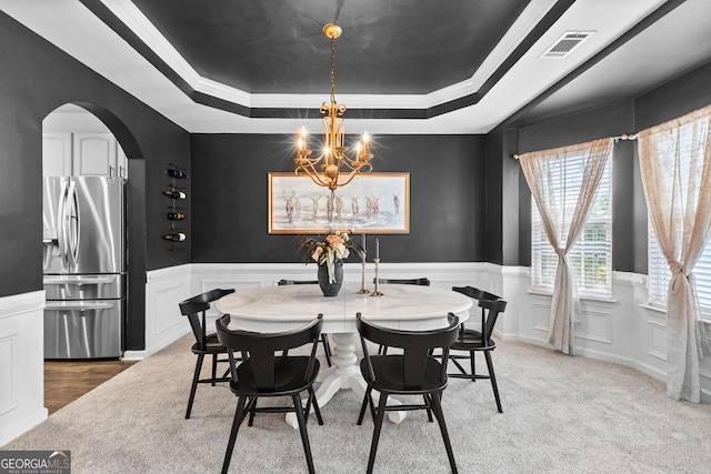 3 Stonebridge Way, Newnan, GA 30265 - dining room with a raised ceiling, arched walkways, wainscoting, a decorative wall, and a chandelier