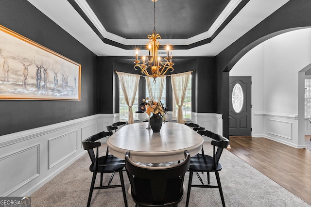 3 Stonebridge Way, Newnan, GA 30265 - dining area with a chandelier, a tray ceiling, arched walkways, a wainscoted wall, and a decorative wall