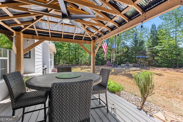 3 Stonebridge Way, Newnan, GA 30265 - wooden deck featuring outdoor dining area, a gazebo, ceiling fan, and view of wooded area