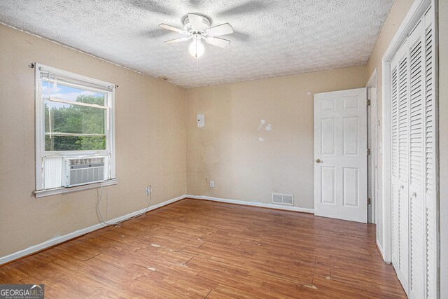 198 Hickory Ave, Demorest, GA 30535 - unfurnished bedroom featuring cooling unit, wood finished floors, baseboards, a textured ceiling, and ceiling fan