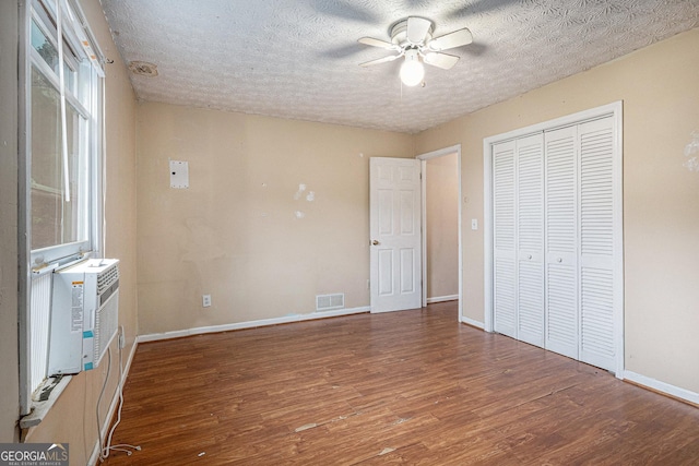 198 Hickory Ave, Demorest, GA 30535 - unfurnished bedroom with wood finished floors, baseboards, a closet, a textured ceiling, and ceiling fan