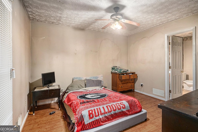 198 Hickory Ave, Demorest, GA 30535 - bedroom with a textured ceiling, wood finished floors, baseboards, and a ceiling fan