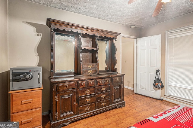 198 Hickory Ave, Demorest, GA 30535 - bedroom with light wood-type flooring, a textured ceiling, and a ceiling fan