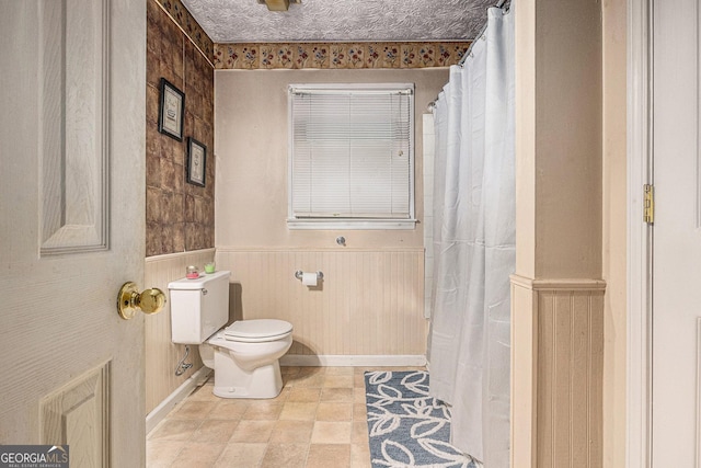 198 Hickory Ave, Demorest, GA 30535 - bathroom with toilet and a wainscoted wall