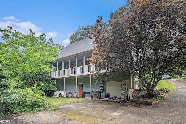 198 Hickory Ave, Demorest, GA 30535 - view of front facade featuring a garage, a sunroom, driveway, and roof with shingles