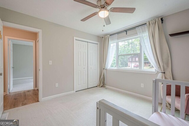 1137 Poplar Log Pl, Austell, GA 30168 - unfurnished bedroom with baseboards, carpet floors, a closet, and a ceiling fan