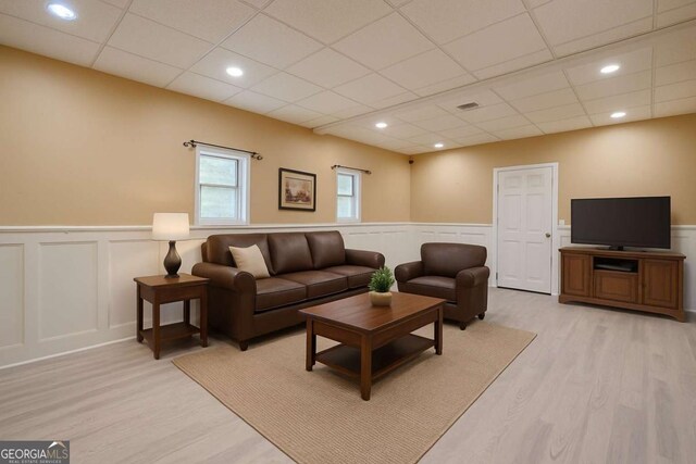 1137 Poplar Log Pl, Austell, GA 30168 - living area featuring wainscoting, a decorative wall, a drop ceiling, and light wood finished floors