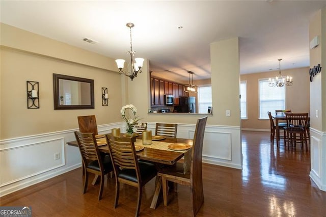 6089 Indian Wood, Mableton, GA 30126 - dining room with a chandelier, wainscoting, dark wood finished floors, and a decorative wall