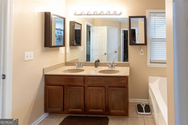 6089 Indian Wood, Mableton, GA 30126 - bathroom featuring double vanity, tile patterned flooring, a garden tub, and baseboards