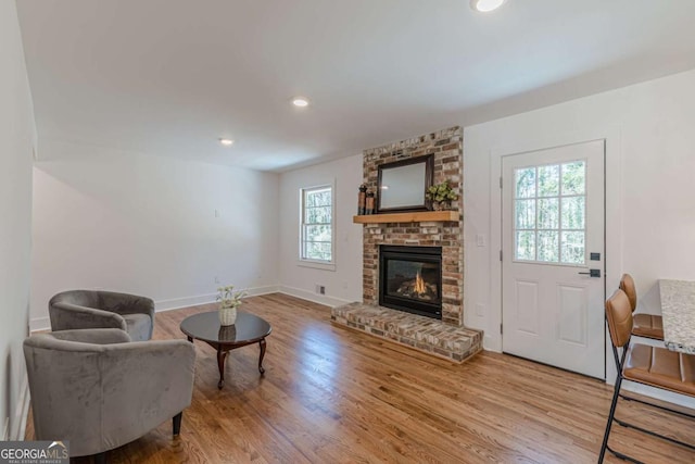 442 Mountain Park Trl, Stone Mountain, GA 30087 - living room featuring wood finished floors, baseboards, a brick fireplace, and recessed lighting
