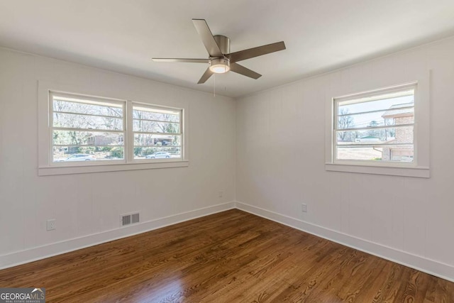 442 Mountain Park Trl, Stone Mountain, GA 30087 - unfurnished room with healthy amount of natural light, dark wood-type flooring, baseboards, and ceiling fan