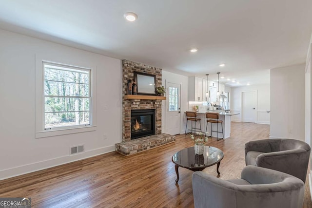 442 Mountain Park Trl, Stone Mountain, GA 30087 - living room featuring light wood-style flooring, baseboards, a fireplace, and recessed lighting