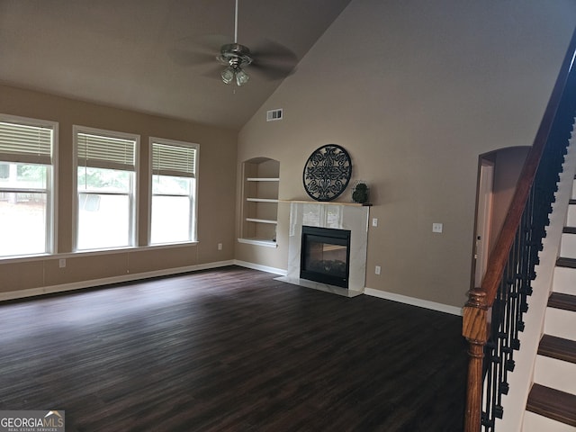 536 Longwood Pl, Dallas, GA 30132 - unfurnished living room featuring built in shelves, ceiling fan, high vaulted ceiling, baseboards, and a premium fireplace