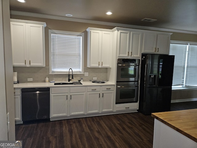 536 Longwood Pl, Dallas, GA 30132 - kitchen with dishwasher, double oven, black fridge, a sink, and dark wood finished floors