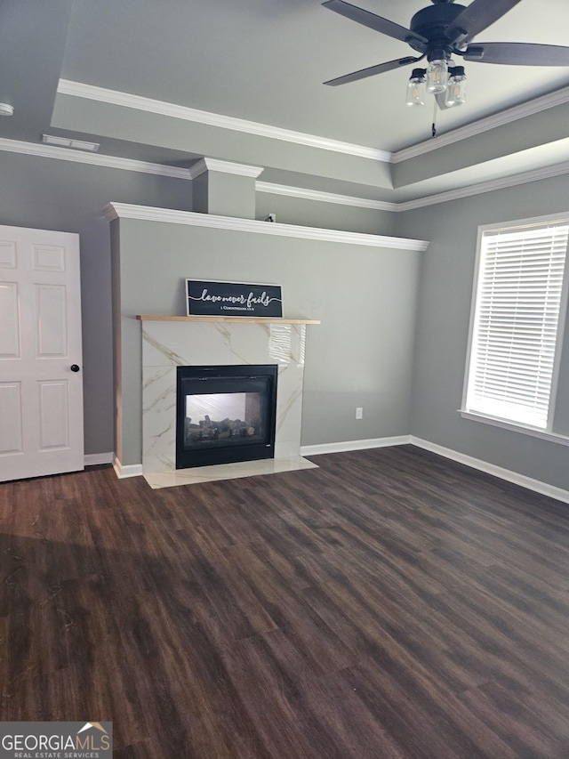 536 Longwood Pl, Dallas, GA 30132 - unfurnished living room with a fireplace, crown molding, ceiling fan, wood finished floors, and a tray ceiling