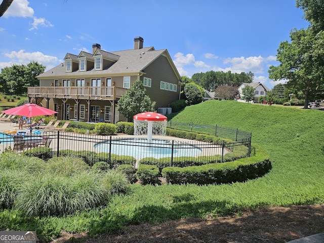 536 Longwood Pl, Dallas, GA 30132 - back of house with a community pool, a chimney, and cooling unit