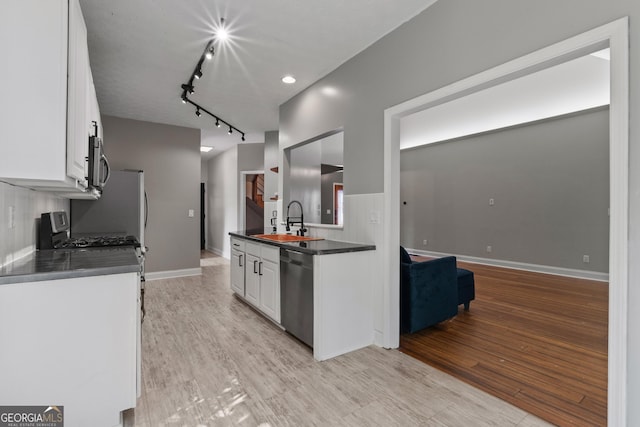 1133 Stone Brook Ln, Bremen, GA 30110 - kitchen featuring stainless steel appliances, a sink, dark countertops, and white cabinetry