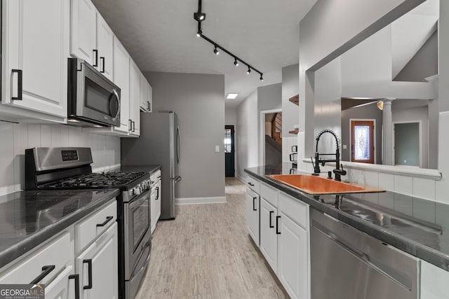 1133 Stone Brook Ln, Bremen, GA 30110 - kitchen featuring stainless steel appliances, a sink, dark countertops, and white cabinetry
