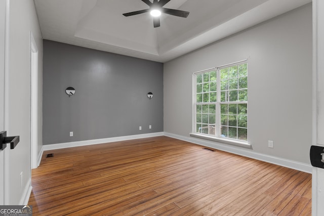 1133 Stone Brook Ln, Bremen, GA 30110 - empty room featuring a raised ceiling, ceiling fan, wood finished floors, and baseboards